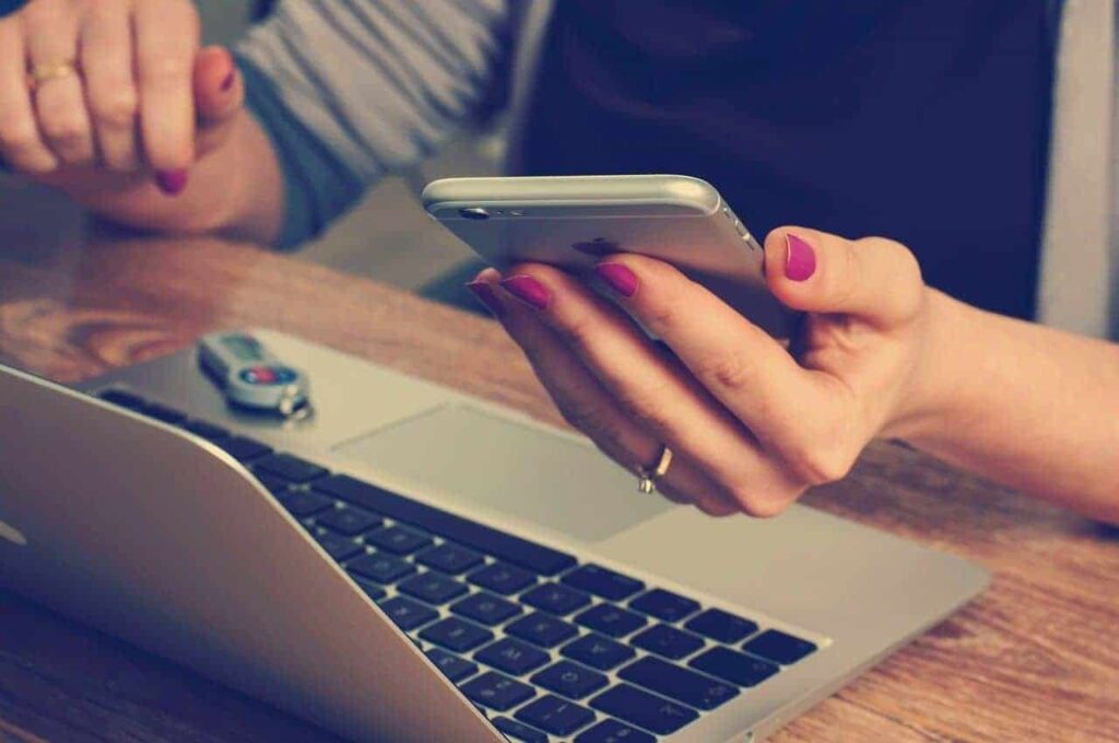 Reasons Why A Mobile-Friendly Website Is A Must-Have 1 woman navigating a mobile-friendly werbsite